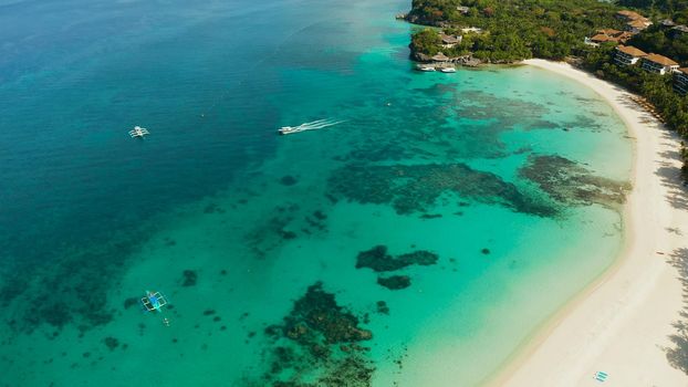 White sandy beach with tourists and hotels in Boracay Island, Philippines, aerial view. Seascape with beach on tropical island. Summer and travel vacation concept.
