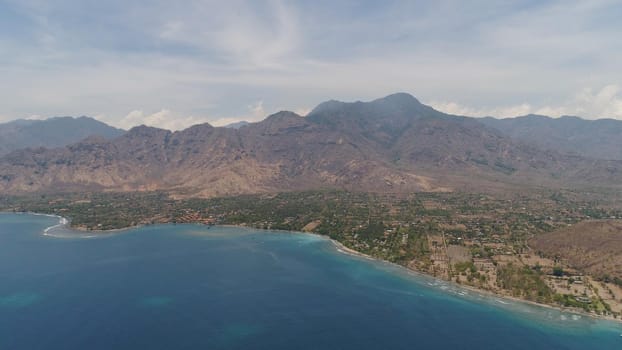 aerial tropical landscape town by sea, mountains, beach, boats on surface water. Bali,Indonesia, travel concept