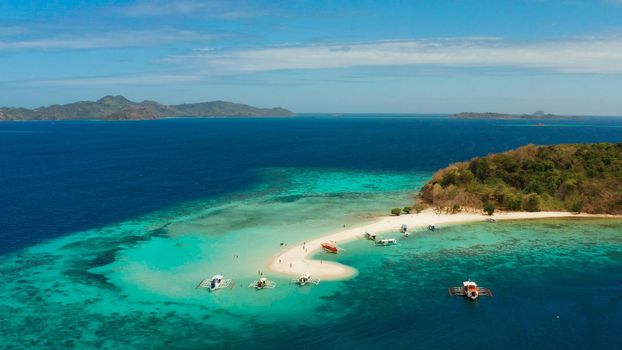 aerial seascape tropical island with sand bar, turquoise water and coral reef. Ditaytayan, Palawan, Philippines. tourist boats on tropical beach. Travel tropical concept. Palawan, Philippines