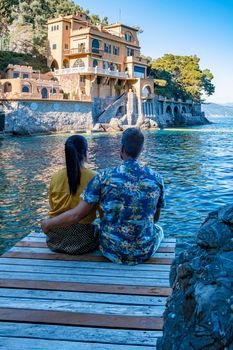 Beautiful sea coast with colorful houses in Portofino, Italy Europe Portofino in Liguria, Italy. Genoa Couple mid age man and woman visiting Italy during vacation