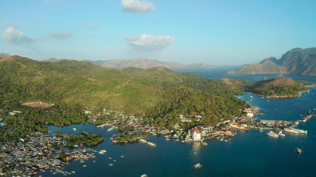 sea port, pier, cityscape Coron town with boats on Busuanga island, Philippines, Palawan. Coron city with slums and poor district. Seascape with mountains.