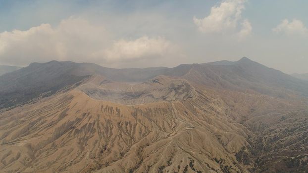 active volcano Bromo with smoking crater. aerial view mountain landscape volcano crater and mountains Tengger Semeru national park.