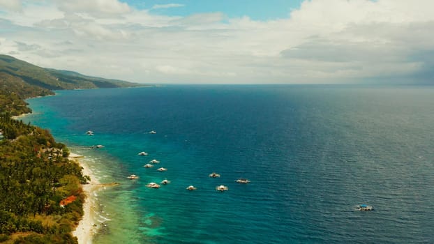 Tropical sandy beach with wave and turquoise water,copy space for text, aerial view. Ocean with waves and tropical beach. Summer and travel vacation concept