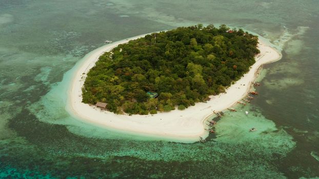 Beautiful beach on tropical island surrounded by coral reef, top view. Mantigue island. Small island with sandy beach. Summer and travel vacation concept, Camiguin, Philippines, Mindanao
