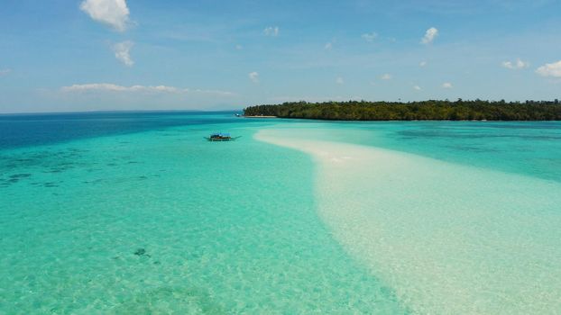 Tropical landscape with a beautiful beach in the blue water and an island with coral reef and atoll. Mansalangan sandbar, Balabac, Palawan, Philippines. Summer and travel vacation concept