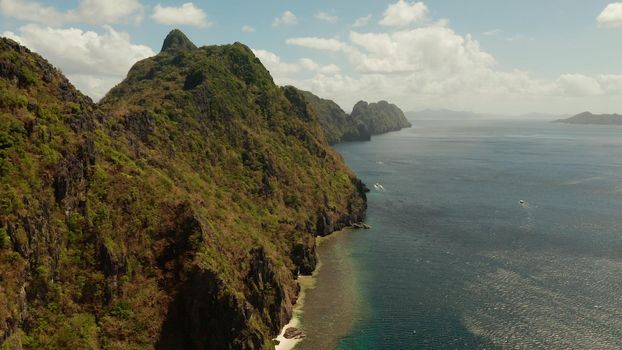 Bay and the tropical islands. Seascape with tropical rocky islands, ocean blue wate, aerial view. islands and mountains covered with tropical forest. El nido, Philippines, Palawan. Tropical Mountain Range