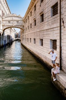 Canals of Venice Italy during summer in Europe,Architecture and landmarks of Venice. Italy Europe, couple man and woman mid age visiting bridge of sights in Venice
