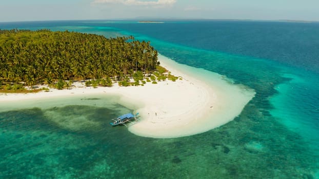 Tropical landscape: small island with beautiful beach, palm trees by turquoise water view from above. Patongong Island with sandy beach. Summer and travel vacation concept.