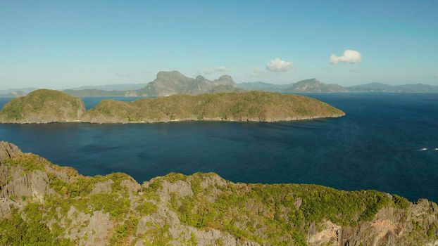 Bay and the tropical islands. Seascape with tropical rocky islands, ocean blue wate, aerial view. islands and mountains covered with tropical forest. El nido, Philippines, Palawan. Tropical Mountain Range