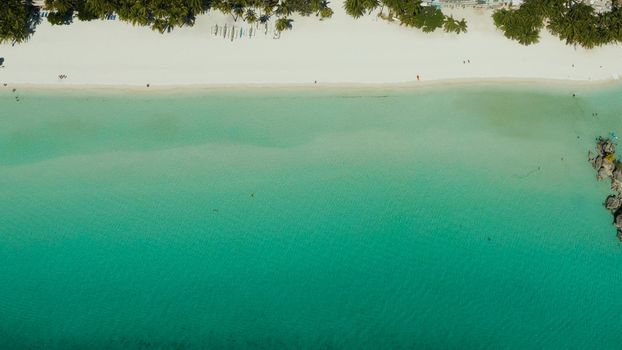 Tropical white sand beach in a lagoon with turquoise water on Boracay Island, Philippines., aerial view. Seascape with beach on tropical island. Summer and travel vacation concept.