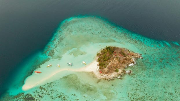 aerial seascape tropical island and sand beach, turquoise water and coral reef. malacory island, Philippines, Palawan. tourist boats on coast tropical island.