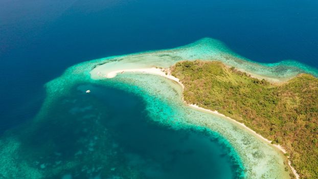 aerial seascape tropical island with sand bar, turquoise water and coral reef. Ditaytayan, Palawan, Philippines. tourist boats on tropical beach. Travel tropical concept. Palawan, Philippines