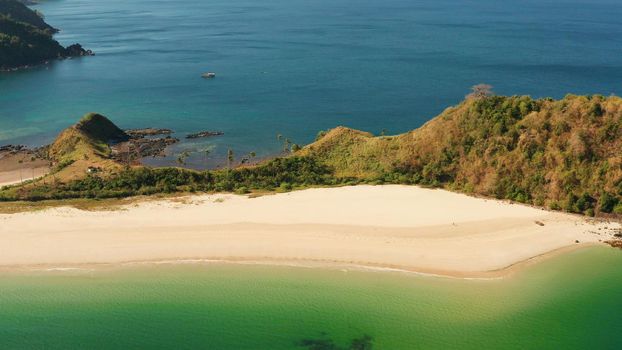 Blue sea and tropical beach, aerial drone. Nacpan, El Nido, Palawan, Philippine Islands. Seascape with tropical beach and islands. Summer and travel vacation concept