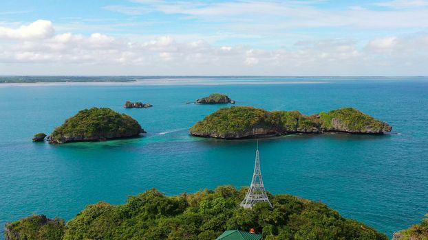 Seascape with a cluster of tropical Islands in turquoise water, aerial seascape. Hundred Islands National Park, Pangasinan, Philippines. Famous tourist attraction, Alaminos. Summer and travel vacation concept