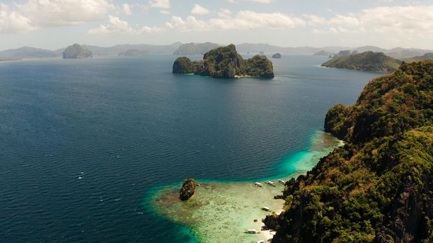 aerial view tropical lagoon with sandy beach surrounded by cliffs. El nido, Philippines, Palawan. beautiful lagoon and karst scenery.