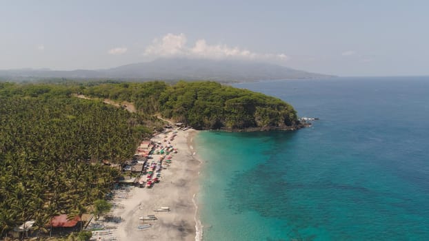 sandy beach with palm trees in tropical resort. aerial seascape sand beach with turquoise water. Seascape, ocean and beautiful beach.Travel concept. Indonesia, Bali
