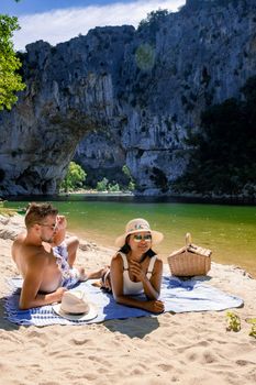 couple men and woman visiting The famous natural bridge of Pont d'Arc in Ardeche department in France Ardeche. Europe Rhone Alpes