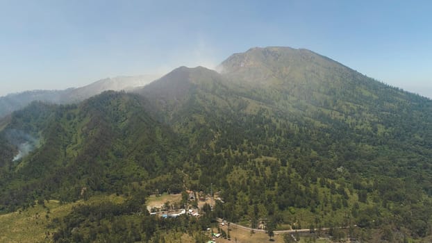 aerial view forest fire smoke on slopes hills. wild fire in tropical forest, Java Indonesia. natural disaster fire in Southeast Asia