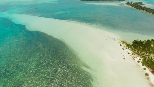 Coast of a tropical island with a sandy beach and turquoise water, top view. Punta Sebaring, Balabac, Palawan. Summer and travel vacation concept.