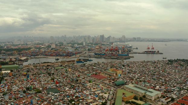 Manila city with port, skyscrapers, modern buildings and Makati business center aerial drone. Travel vacation concept