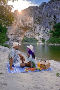 couple men and woman visiting The famous natural bridge of Pont d'Arc in Ardeche department in France Ardeche. Europe Rhone Alpes