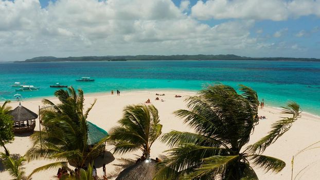 Tropical landscape: Daco island with beautiful beach, palm trees by turquoise water view from above. Siargao, Philippines. Summer and travel vacation concept