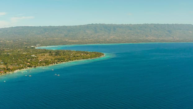 Coastline with coral reef and blue water, diving site, Moalboal, Philippines. Aerial view, Summer and travel vacation concept.