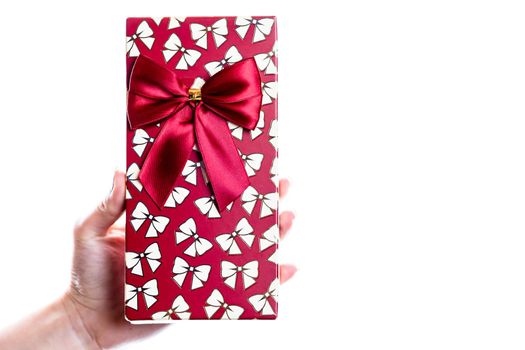 Hand showing holding giving or receiving gift present box isolated on white background.