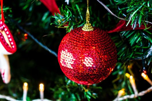 Christmas hanging decorations on fir tree. Decorated Christmas tree. Fir branch with Christmas baubles decorations.