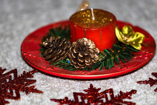 Close up of decorated christmas red candle isolated. Christmas composition with seasonal decorations and ornaments, colorful christmas background christmassy mood concept.