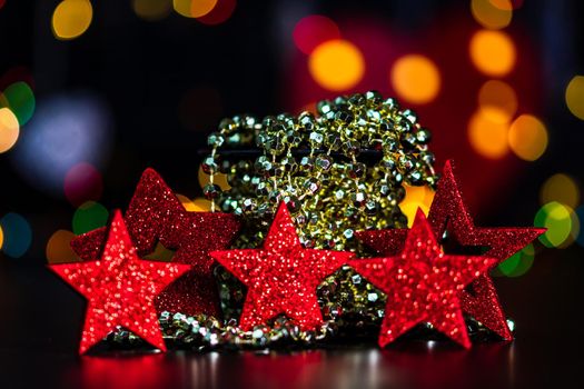 Decorations and ornaments in a colorful Christmas composition isolated on background of blurred lights.