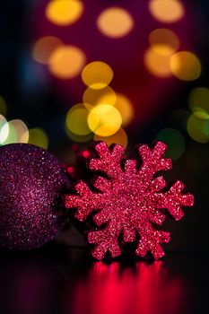 Decorations and ornaments in a colorful Christmas composition isolated on background of blurred lights.