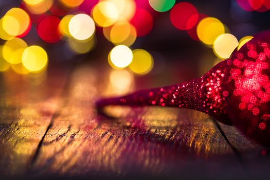 Decorations and ornaments in a colorful Christmas composition isolated on background of blurred lights.