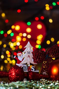 Decorations and ornaments in a colorful Christmas composition isolated on background of blurred lights.