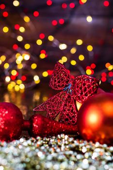 Decorations and ornaments in a colorful Christmas composition isolated on background of blurred lights.