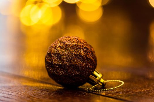 Colorful Christmas ball isolated on blurred and shiny background of lights. Christmas baubles isolated.