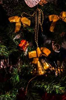 Christmas hanging decorations on fir tree. Decorated Christmas tree. Fir branch with Christmas baubles decorations.