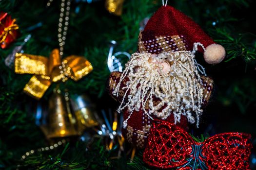 Christmas hanging decorations on fir tree. Decorated Christmas tree. Fir branch with Christmas baubles decorations.