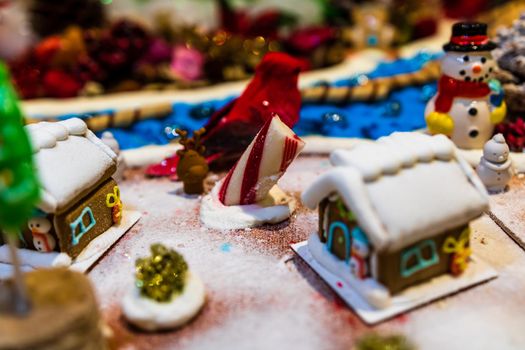 Colorful gingerbread house isolated on blurred background with Christmas decoration.