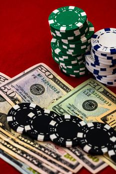 Stacks of poker chips with money on red background, USD currency