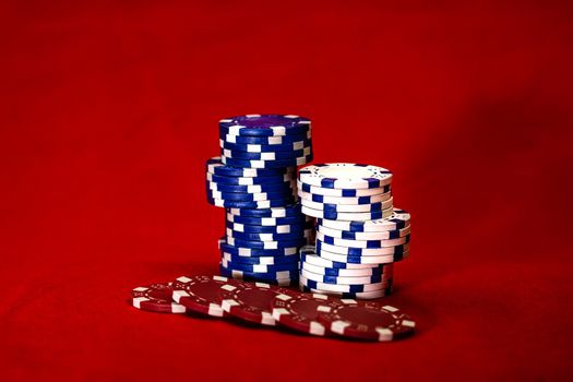 Mix of poker chips on red background