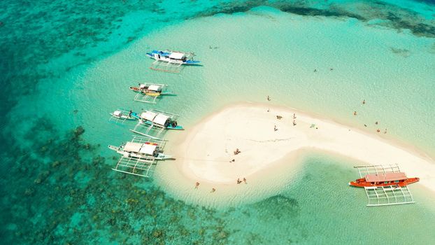 aerial seascape tropical island with sand bar, turquoise water and coral reef. Ditaytayan, Palawan, Philippines. tourist boats on tropical beach. Travel tropical concept. Palawan, Philippines