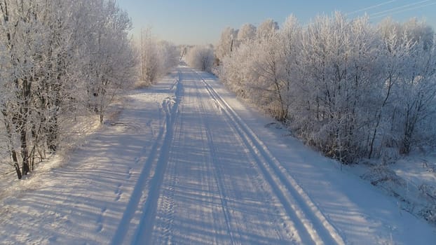 aerial view winter landscape with road and trees covered snow. winter in countryside