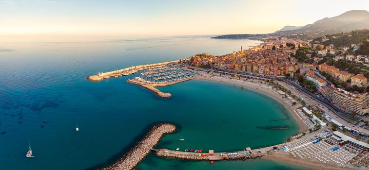  Sand beach beneath the colorful old town Menton on french Riviera, France. Drone aerial view over Menton France Europe