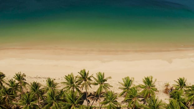 Wide sand beach Nacpan Beach, aerial view. El Nido, Palawan, Philippine Islands. Seascape with tropical beach and islands. Summer and travel vacation concept