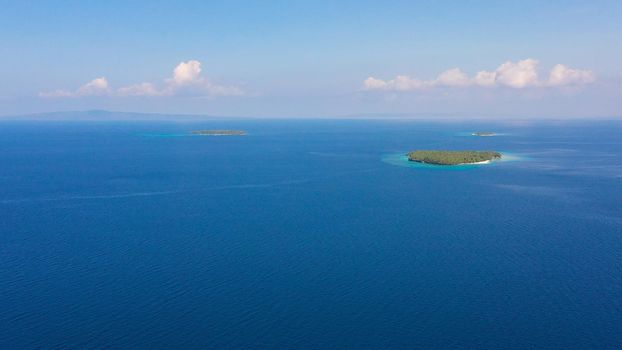 Blue sea and islands with white beaches, top view. Philippine Islands. Seascape with islands in the afternoon. Summer and travel vacation concept.