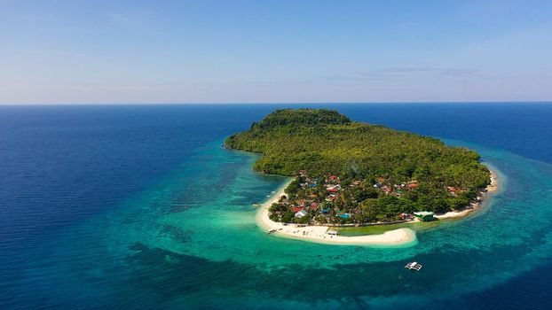 White sand beach and boats. Tropical island for tourists, top view. Himokilan Island, Leyte, Philippines. Summer and travel vacation concept.