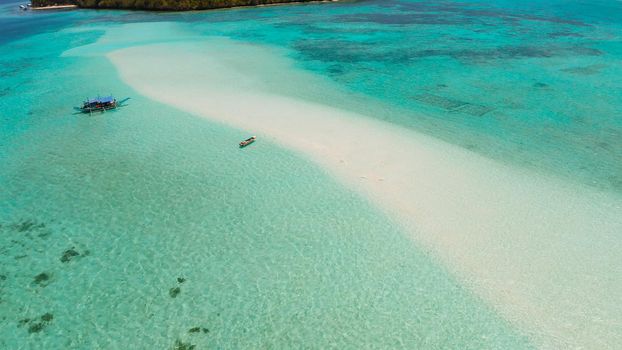 Sand bar in transparent turquoise water top view. Tropical beach with tourists. Mansalangan sandbar, Balabac, Palawan, Philippines. Summer and travel vacation concept