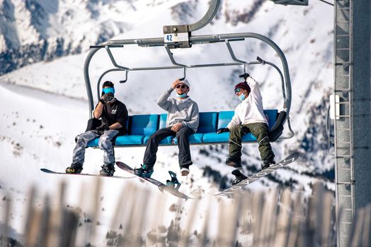 El Tarter, Andorra : 2021 Febraury 2 : Young people on the Chairlift going up to the Grandvalira ski resort in Andorra in 2021
