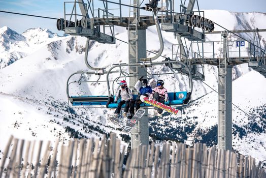El Tarter, Andorra : 2021 Febraury 2 : Young people on the Chairlift going up to the Grandvalira ski resort in Andorra in 2021